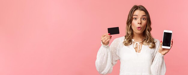 Finance shopping and technology concept closeup portrait of excited blond cute girl in white dress f