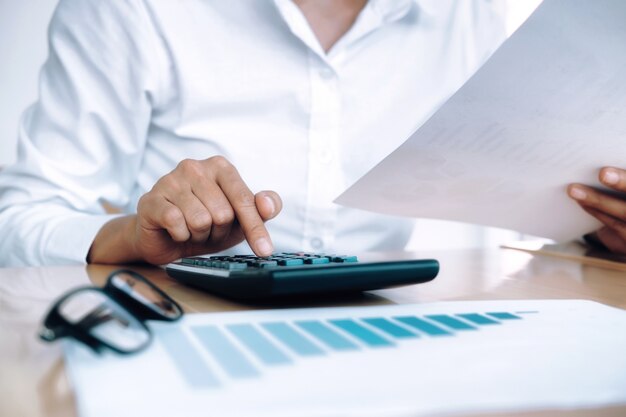 Free photo finances saving economy concept. female accountant or banker use calculator.