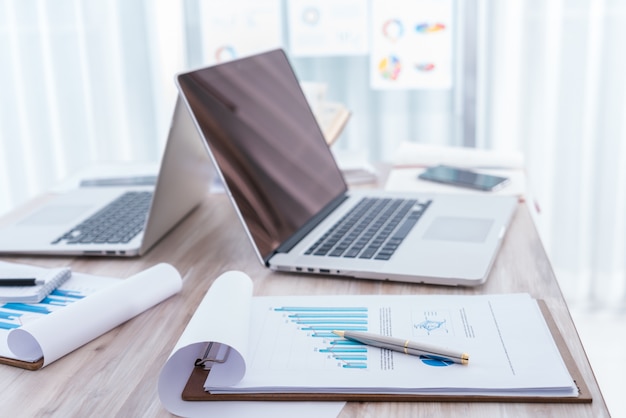 Financial charts on the table with laptop