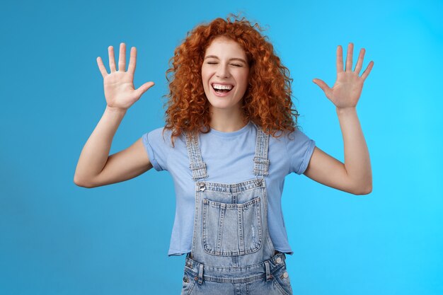 Fine you won. Cheerful carefree playful attractive redhead curly girlfriend having fun laughing out loud joyful raise hands up surrender fool around enjoy cool awesome time spending friend. Copy space