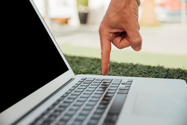 Finger pointing at laptop keyboard