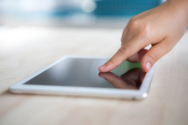 Finger touching the screen of a tablet