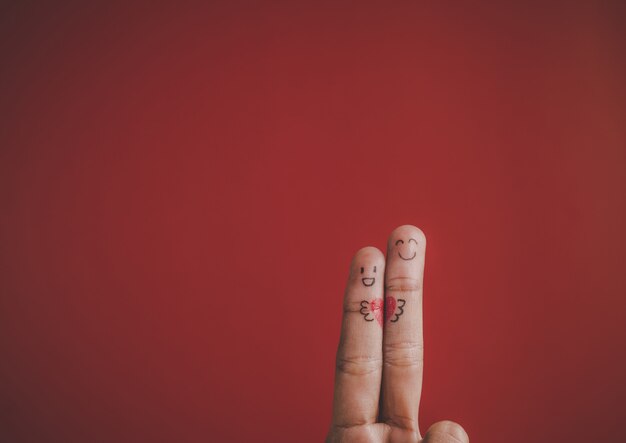 Finger with emotion on red background