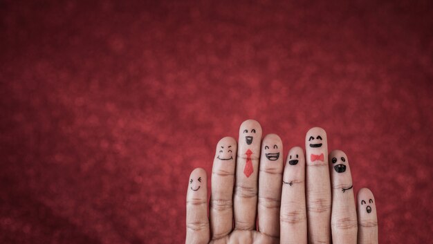 Finger with emotion on red background