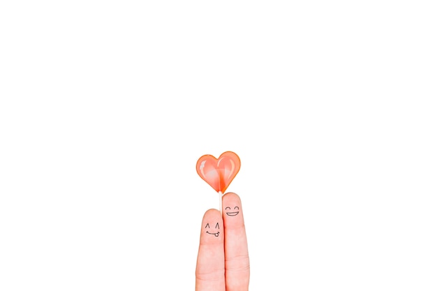 Fingers with faces holding lollipop