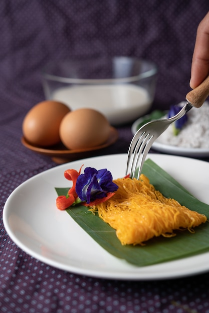 The Fios de ovos on the plate consists of two eggs and coconut milk.