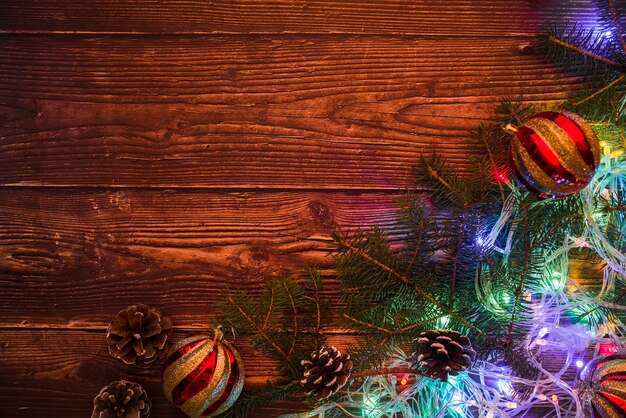 Fir tree branches with baubles and garland 