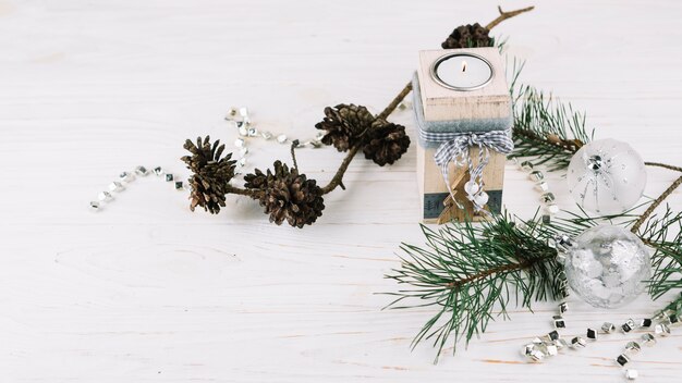 Fir tree branches with candle in candlestick