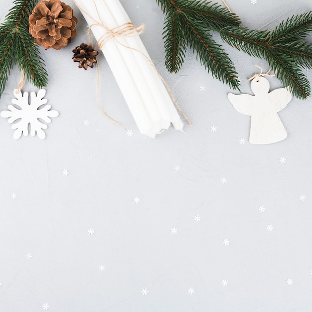 Fir tree branches with candles on table