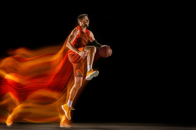 Free photo the fire tracks. young caucasian basketball player of red team in action