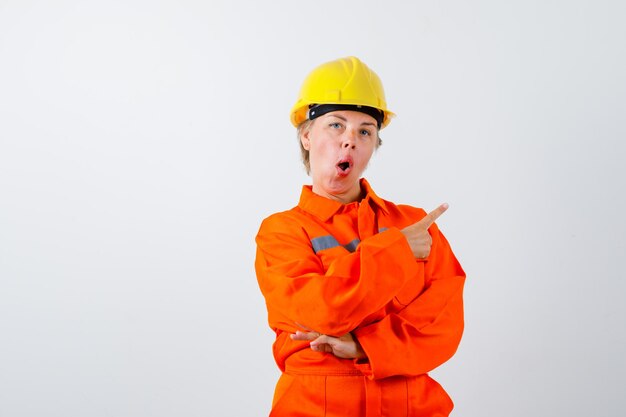 Free photo firewoman in her uniform with a safety helmet