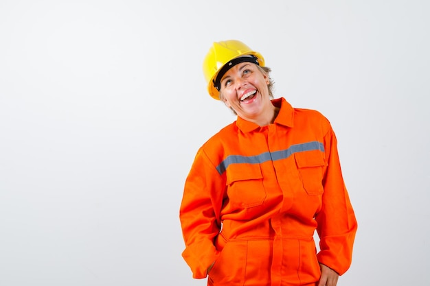 Free photo firewoman in her uniform with a safety helmet