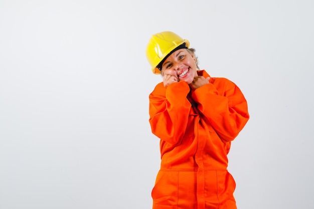 Free photo firewoman in her uniform with a safety helmet