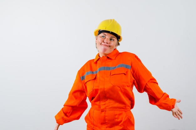 Free photo firewoman in her uniform with a safety helmet