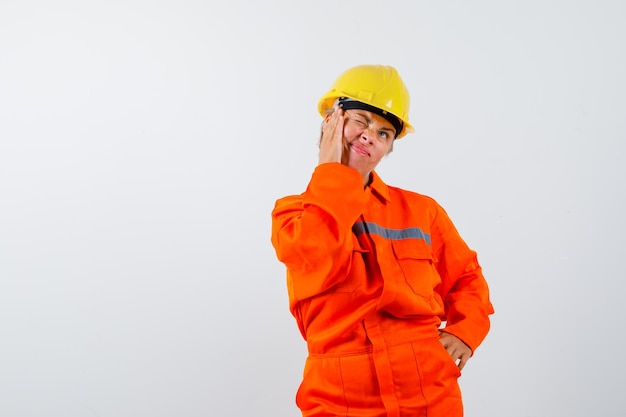 Free photo firewoman in her uniform with a safety helmet