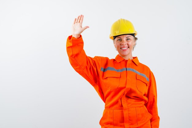 Free photo firewoman in her uniform with a safety helmet