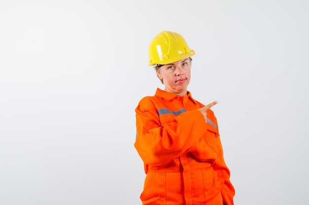 Free photo firewoman in her uniform with a safety helmet