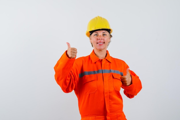 Free photo firewoman in her uniform with a safety helmet