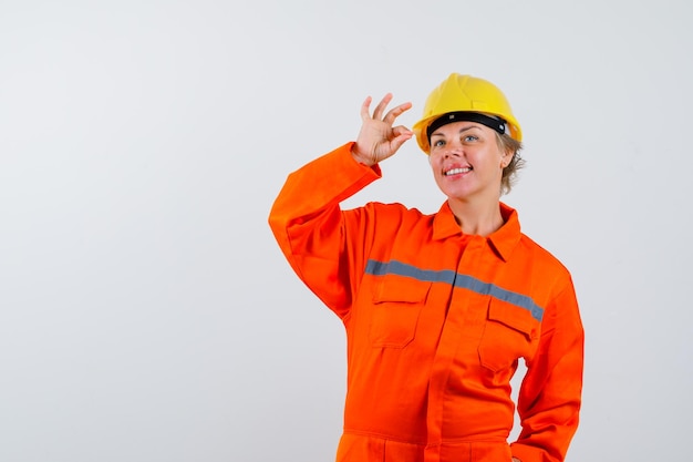 Free photo firewoman in her uniform with a safety helmet