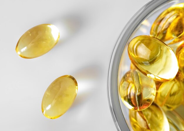 Fish oil capsules in a glass bowl