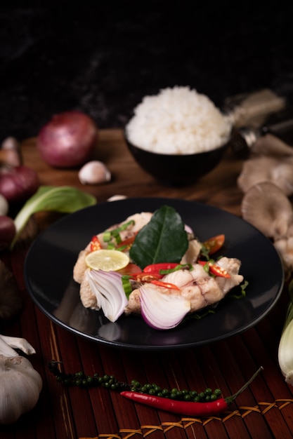 Fish salad with lime, chili, lemongrass, onions, red onions, parsley and kaffir lime leaves in the plate