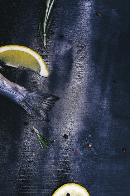 Fish with lemon on rustic board