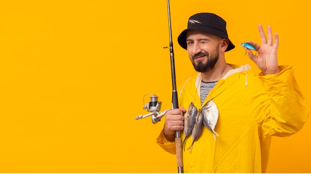 Free photo fisherman holding fishing rod with bait