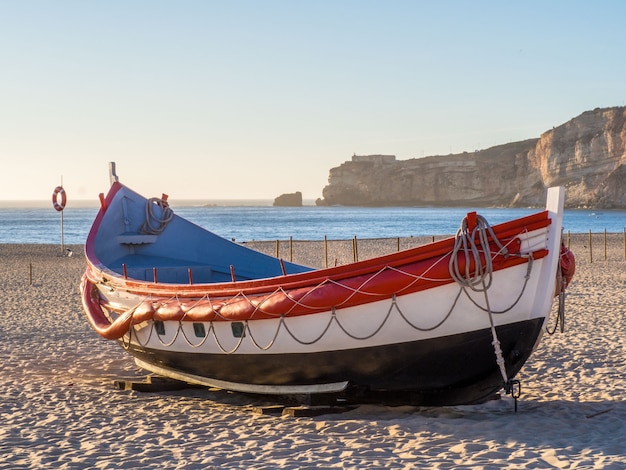 Fishing boat on the beach of Nazare in Portugal during daytime
