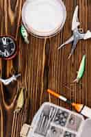 Free photo fishing equipments on wooden background texture