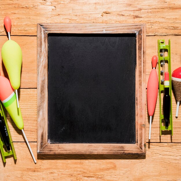 Fishing floats with blank slate on wooden placard