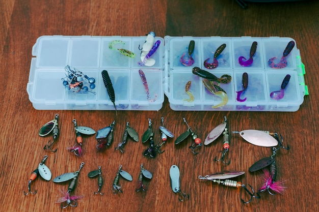 Fishing lures with boxes on wooden desk