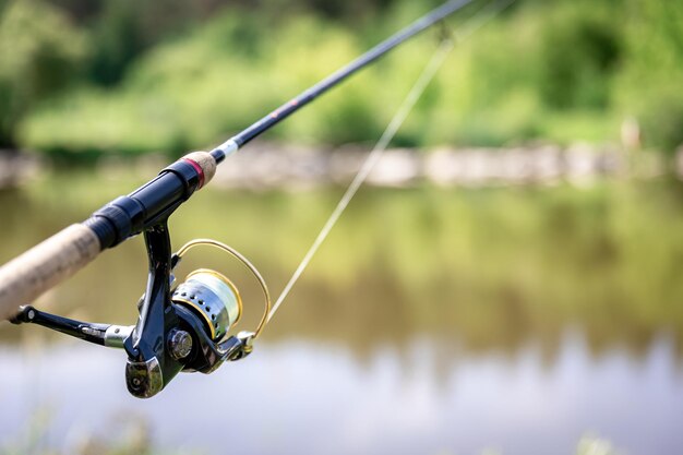 Fishing reel closeup on the background of the river