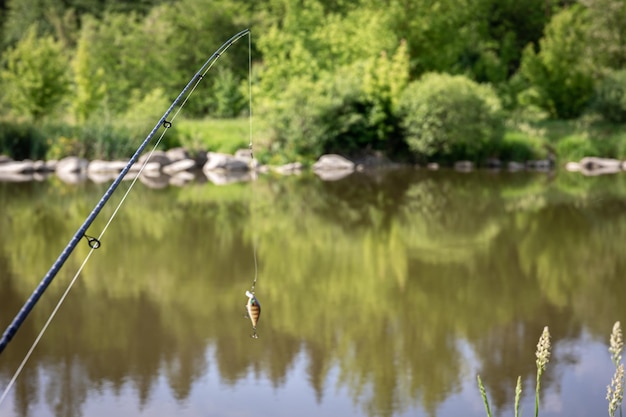 Fishing rod on a blurred background of the lake
