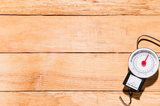 Fishing weighing scale on wooden table