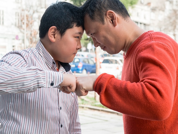 Free photo fist bump asian father and son