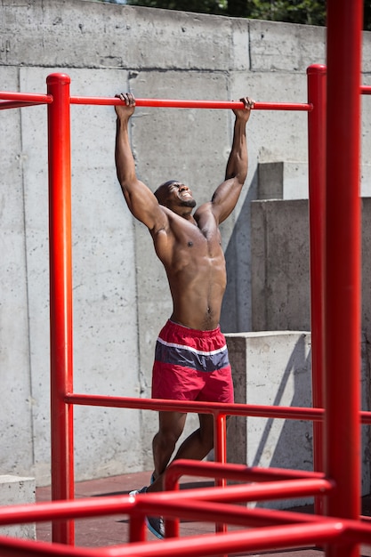 The fit athlete doing exercises at stadium