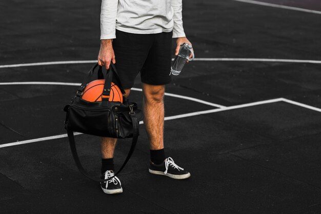 Fit athlete holding sports bag