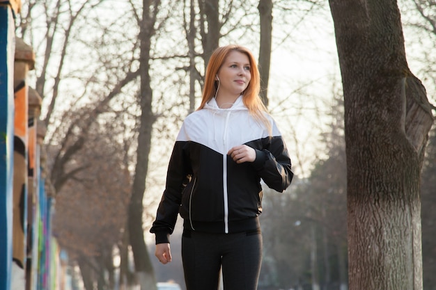 Fit girl sports walking in the morning street