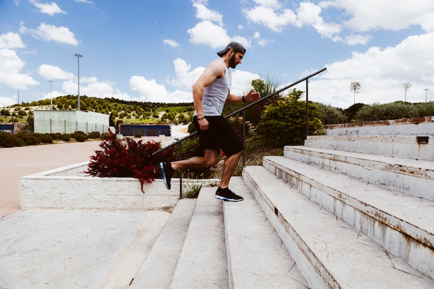 Fit healthy man running on staircase