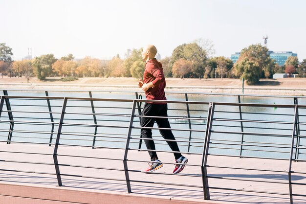 Fit male athlete running outdoors to stay healthy