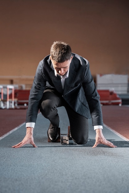 fit man ready to run in suit full shot