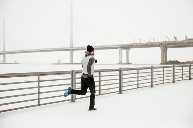 Fit man running outside full shot