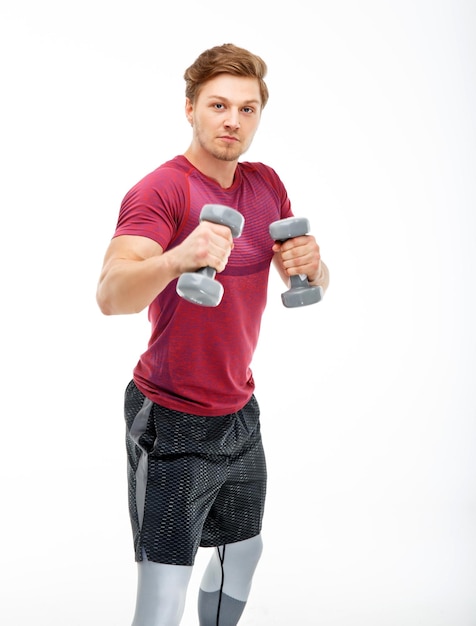 Fit man in a sportswear with dumbbells isolated on a white background.