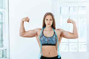 Free photo fit strong man and a woman posing on white