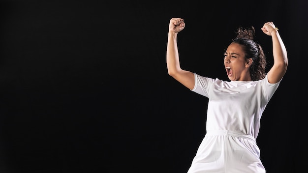 Fit woman celebrating in sportswear