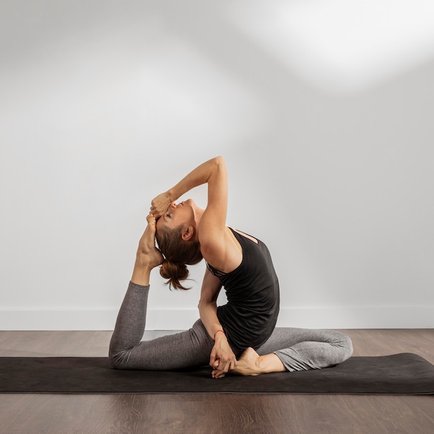 Fit woman doing yoga at home