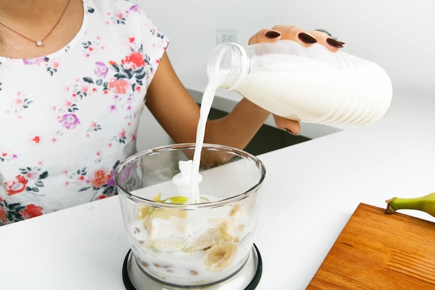 Fit woman makes a yogurt in the kitchen