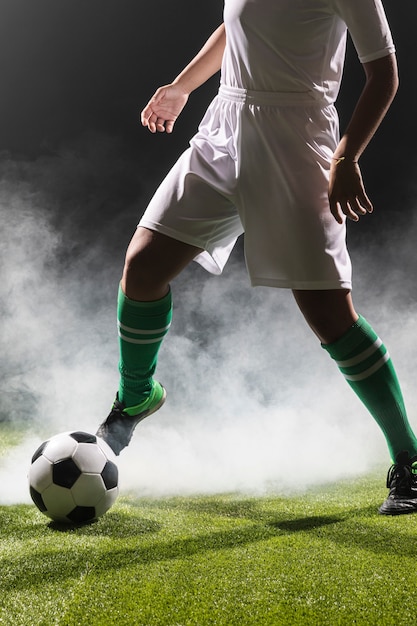 Fit woman playing with soccer ball