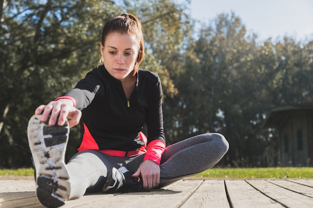 Fit woman stretching her leg