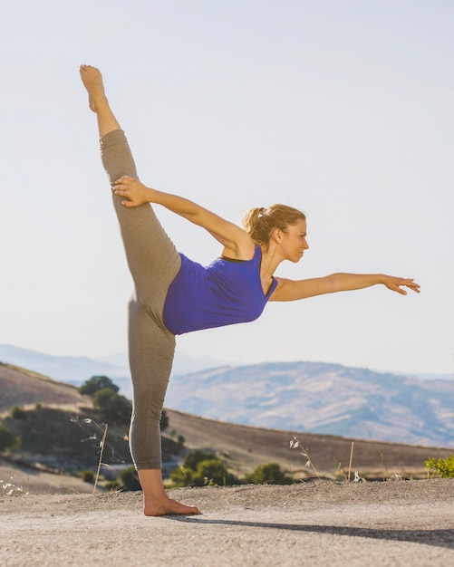 Fit woman stretching leg up